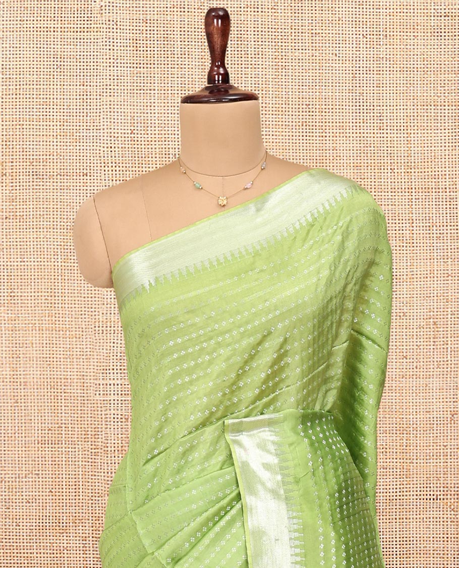 Light Green Banana Pith Saree, Lightly Embellished with Buttas All Over Its Body, Highlighted by a Zari Temple Border, Gleaming Zari Striped Pallu, and Paired with a Matching Blouse
