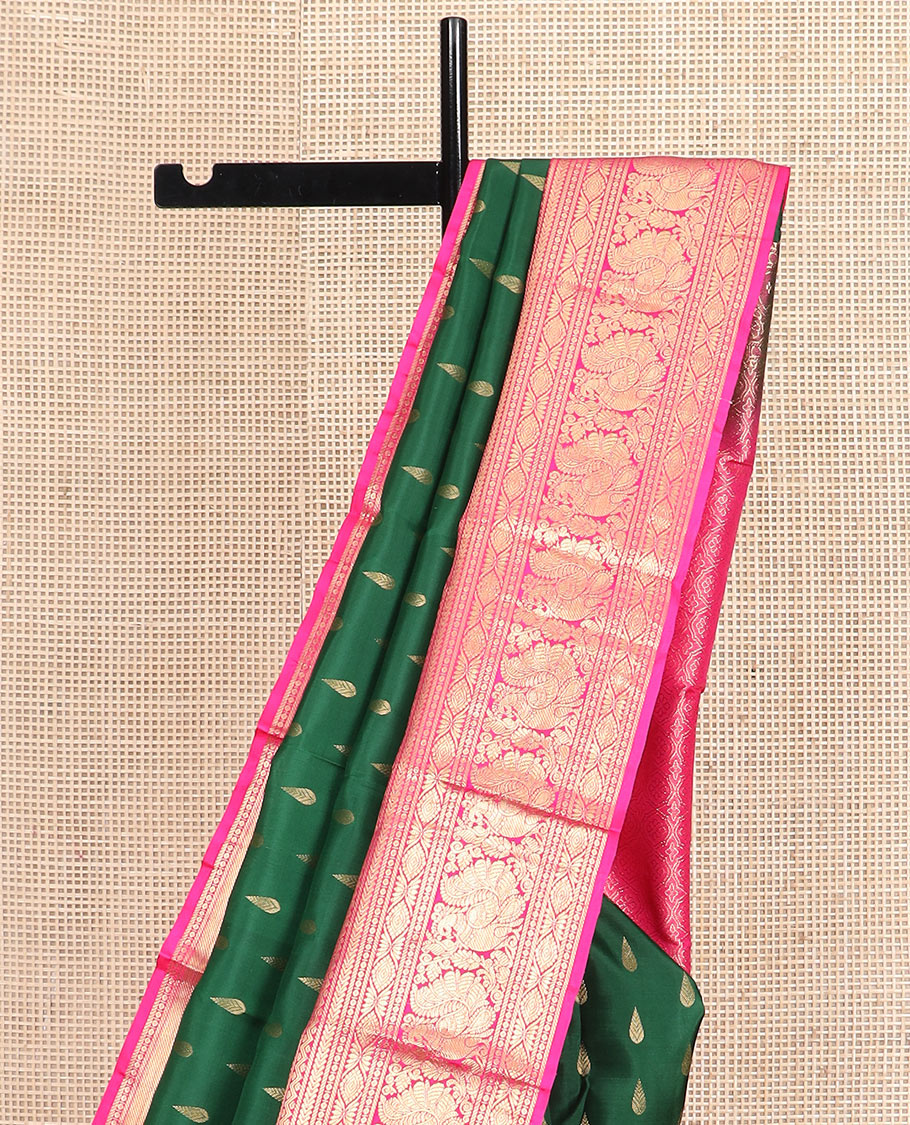 Green thilakam buttas silk saree, contrast border of rekku, muthu, kathir, neli, laddu kamalam, and mayil designs, and jaal pallu