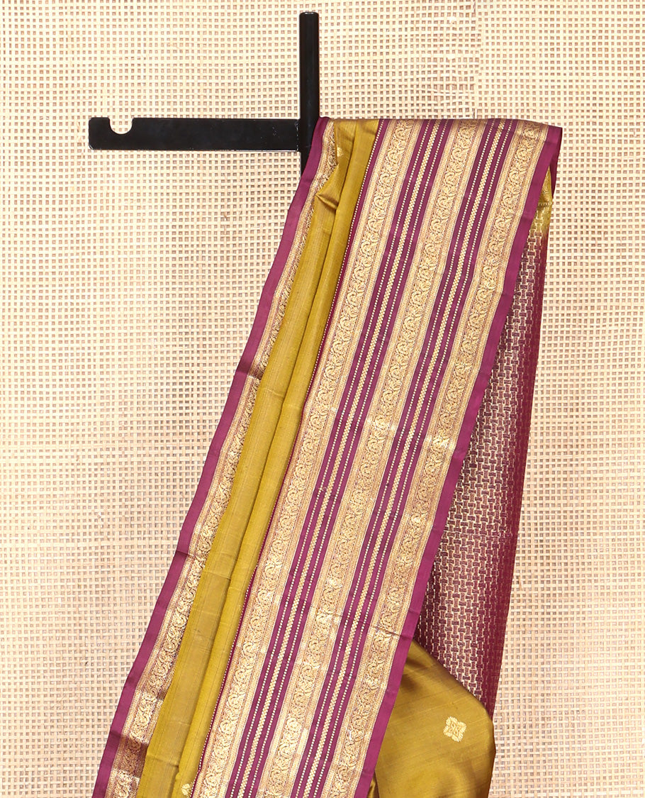 Green Vasundhara Silk Saree, Embellished with Zari Buttas All Over Its Body, Complemented by Contrast Border of Rekku, Muthu, Kathir, And Mayil Designs, Paiyadi Kattam Pallu, and Paired with a Contrast Blouse