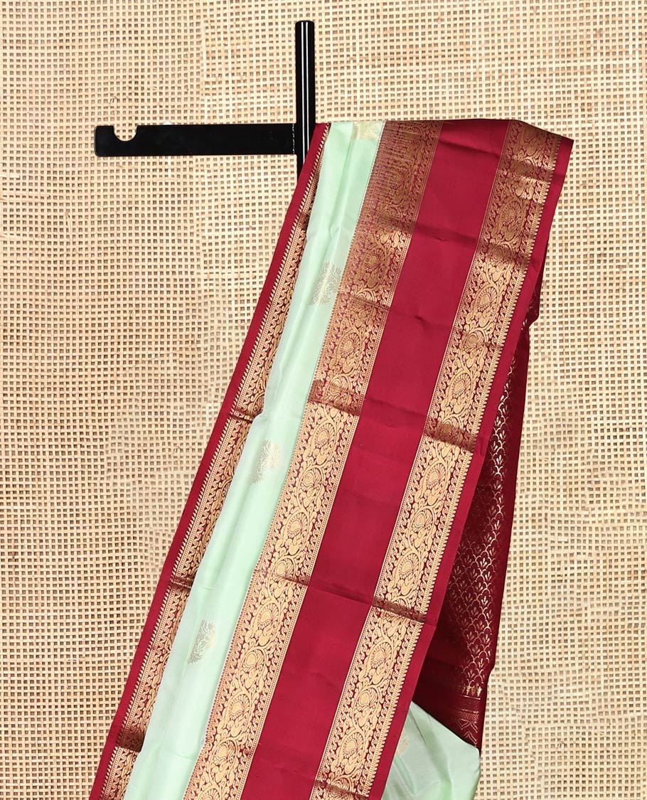 Green Zari Buttas Vasundhara Silk Saree Adorned with a Contrast Rettai Pettu Border of Rekku, Muthu, and Kodi Mayil Designs, Grand Pallu, and a Contrast Blouse