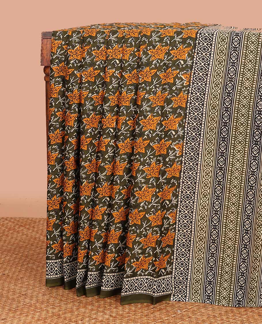 green floral printed mul mul cotton saree, diamond patterns printed border, and pallu of geometric print