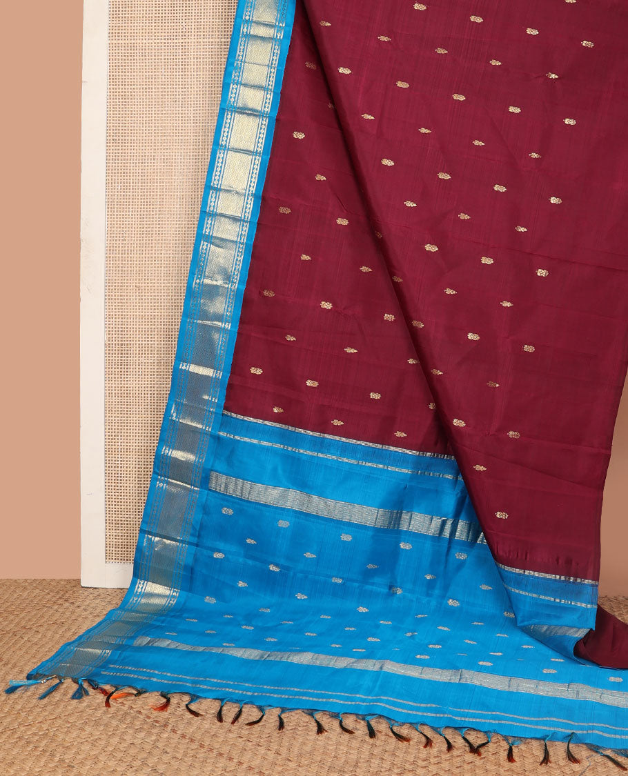 Maroon zari buttas Kanchipuram silk saree, contrast one-sided korvai border of lavangam, and mayil kann designs, and zari design pallu