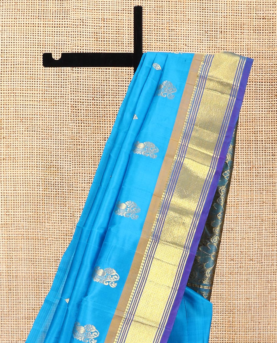 Blue Kanchipuram Silk Saree, Highlighted with Zari Buttas All Over Its Body, Complemented by a Contrast One-Sided Border of Panner Sombu, Banaras, Muthu, and Mayil Kann Designs, Pallu of Floral Designs, and Comes Without a Blouse
