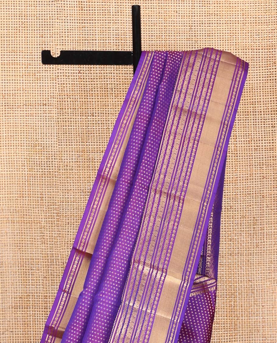 Violet Vasundhara Silk Saree, Gracefully Embellished with Zari Buttas on Its Body, Highlighted by Zari Border of Manga, Cross Kamalam, Jada Nagam, Rudraksham, and Mayil Kann Designs, Grand Jaal Pallu, and Paired with a Matching Blouse