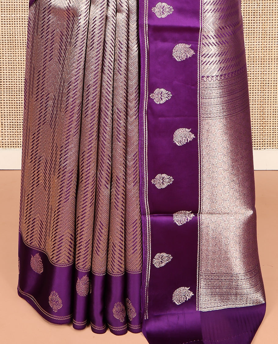 Purple Russian Dola Silk Saree, Meticulously Crafted with Zari Zig-Zag Jacquard on Its Body, Highlighted by Zari Buttas Woven Satin Border, Intricately Designed Pallu, and Paired with a Matching Blouse