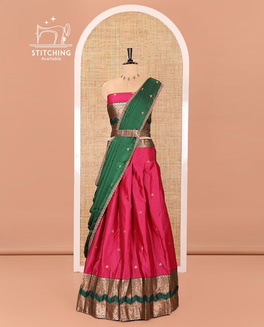 Pink and Green Semi-Banarasi Half-Saree Elevated with Zari Buttas on Its Skirt, Complemented by Contrast Traditional Zari Border of Chakram Designs, Paired with a Matching Blouse, and a Satin Georgette Embroidered Scallop Dhavani