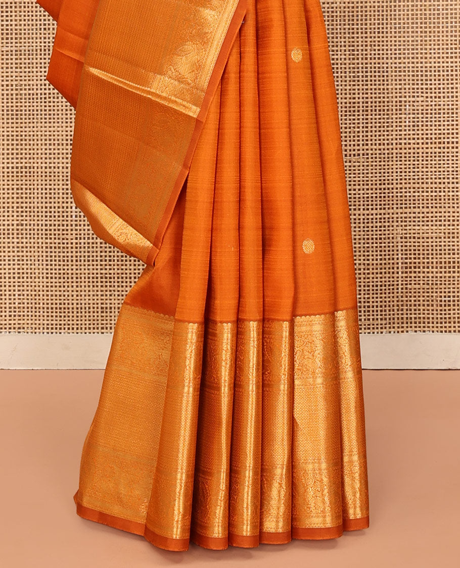 Orange Kanchipuram Silk Saree, Decked Up with Mayil Buttas All Over Its Body, Highlighted by Zari Border of Salngai, Mayil, Yaanai, and Mayil Kann Designs, Subtly Enriched Jaal Pallu, and Paired with a Matching Blouse