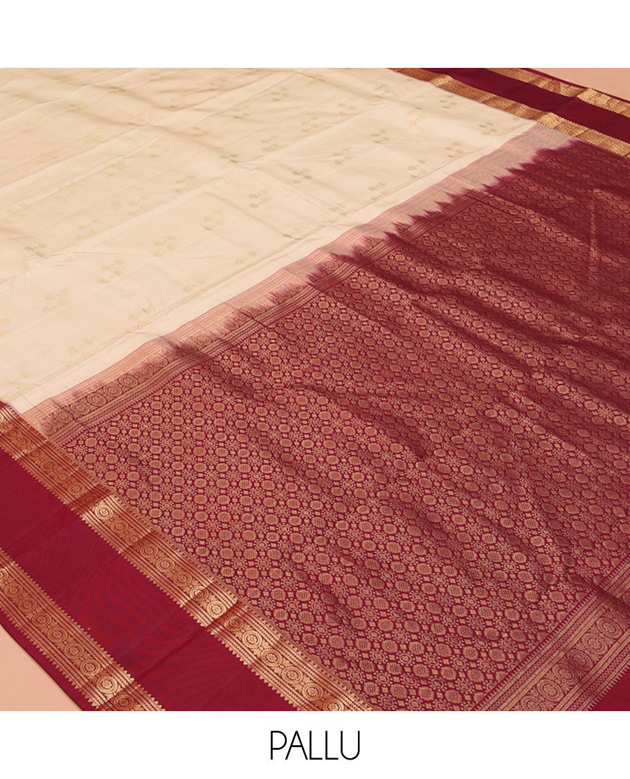 Cream Vasundhara Silk Saree, Steeped in Richness of Zari Buttas All Over Its Body, Complemented by a Contrast Rettai Pettu Border of Rekku, Muthu, and Chakram Designs, Grand Pallu, and Paired with a Contrast Blouse