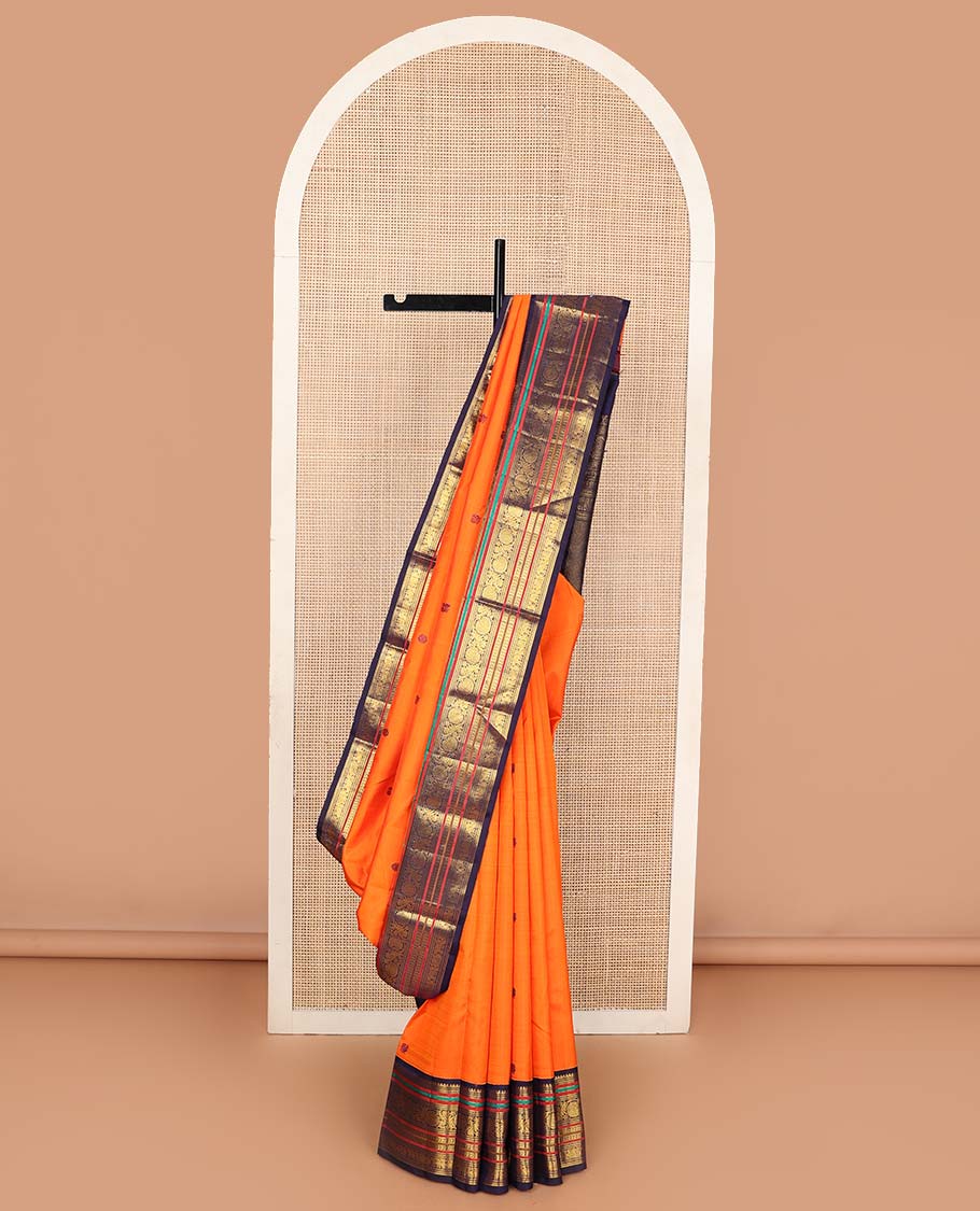Orange annam chakram buttas Kanchipuram korvai silk saree, contrast rettai pettu korvai border of rekku, banaras, muthu, and chakram designs, and poun design steeped pallu