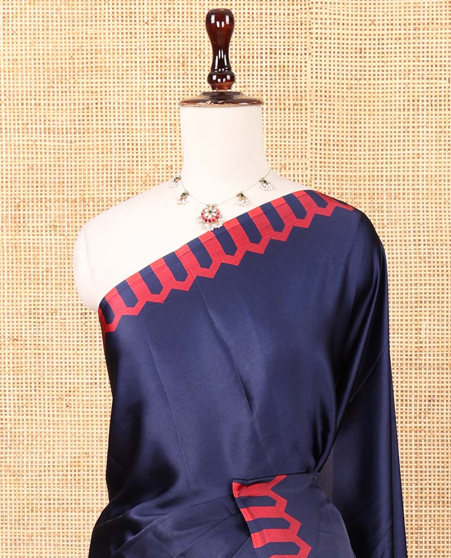 Navy blue plain gajji silk saree features a temple-printed border, a circular-shaped vine-patterned pallu, and a unique motif-printed blouse