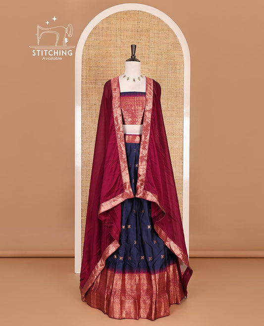 Dark blue taffeta silk half saree, floral zari buttas with contrast green traditional zari border, matching zari blouse, and contrast plain zari border dhavani