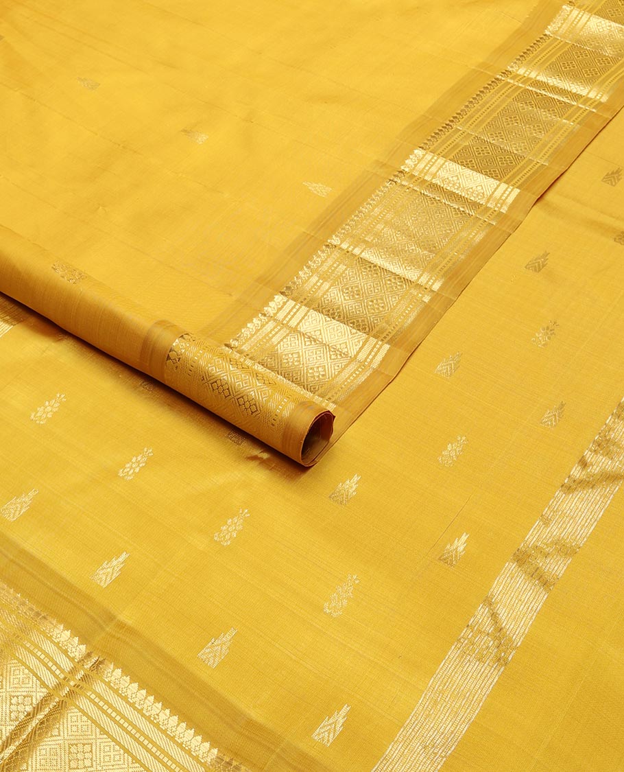 Mustard buttas kancheepuram silk saree with contrast border of thilakam mokku, banaras, muthu,checked design & zari design pallu