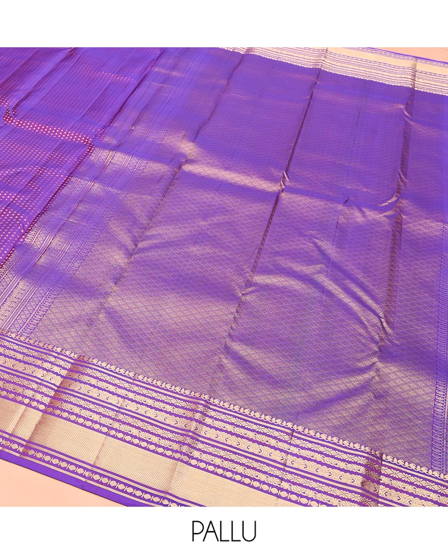 Violet Vasundhara Silk Saree, Gracefully Embellished with Zari Buttas on Its Body, Highlighted by Zari Border of Manga, Cross Kamalam, Jada Nagam, Rudraksham, and Mayil Kann Designs, Grand Jaal Pallu, and Paired with a Matching Blouse