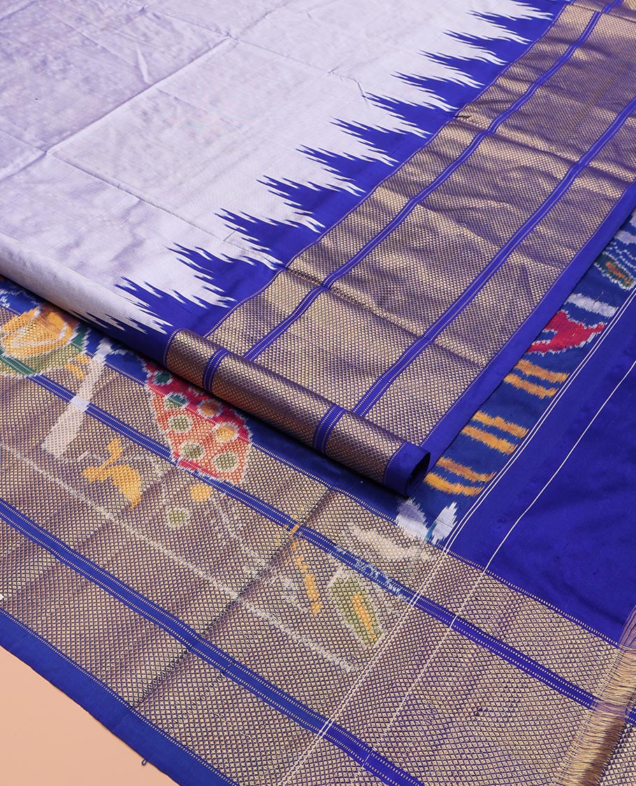 Grey Plain Ikkat Silk Saree, Complemented by a Contrast Temple Border of Diamond Designs, Pallu Features Ikkat Fauna Designs, and Paired with a Contrast Blouse