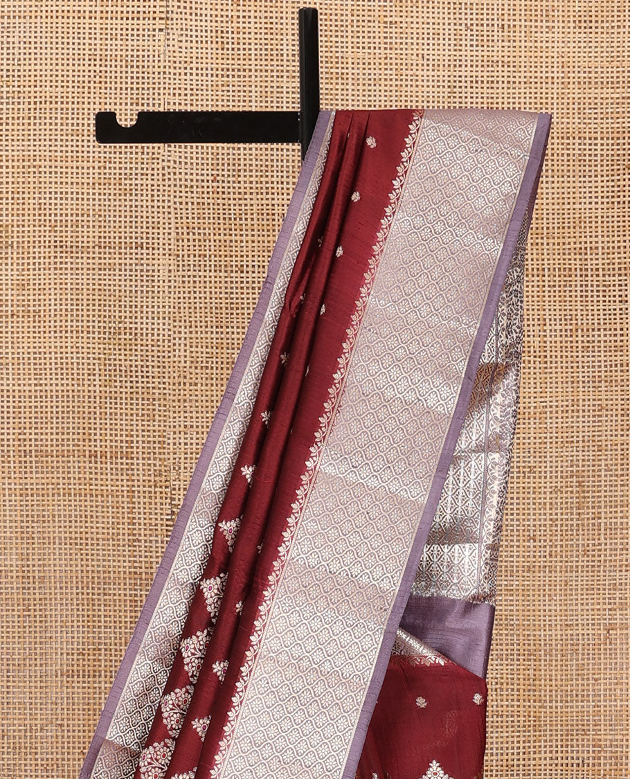 Maroon floral meena buttas raw mango silk saree, contrast floral ogee patterned border, and floral design pallu