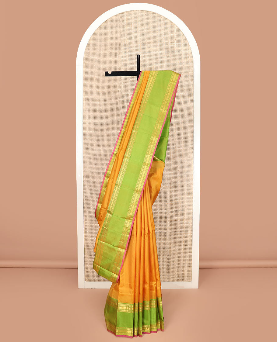 Orange Plain Kanchipuram Silk Saree Accentuated by a Contrast Rettai Pettu Border Featuring Rekku, Banaras, Rudraksham, and Vanki Designs, with a Subtly Zari-Woven Pallu, Paired with a Contrast Blouse