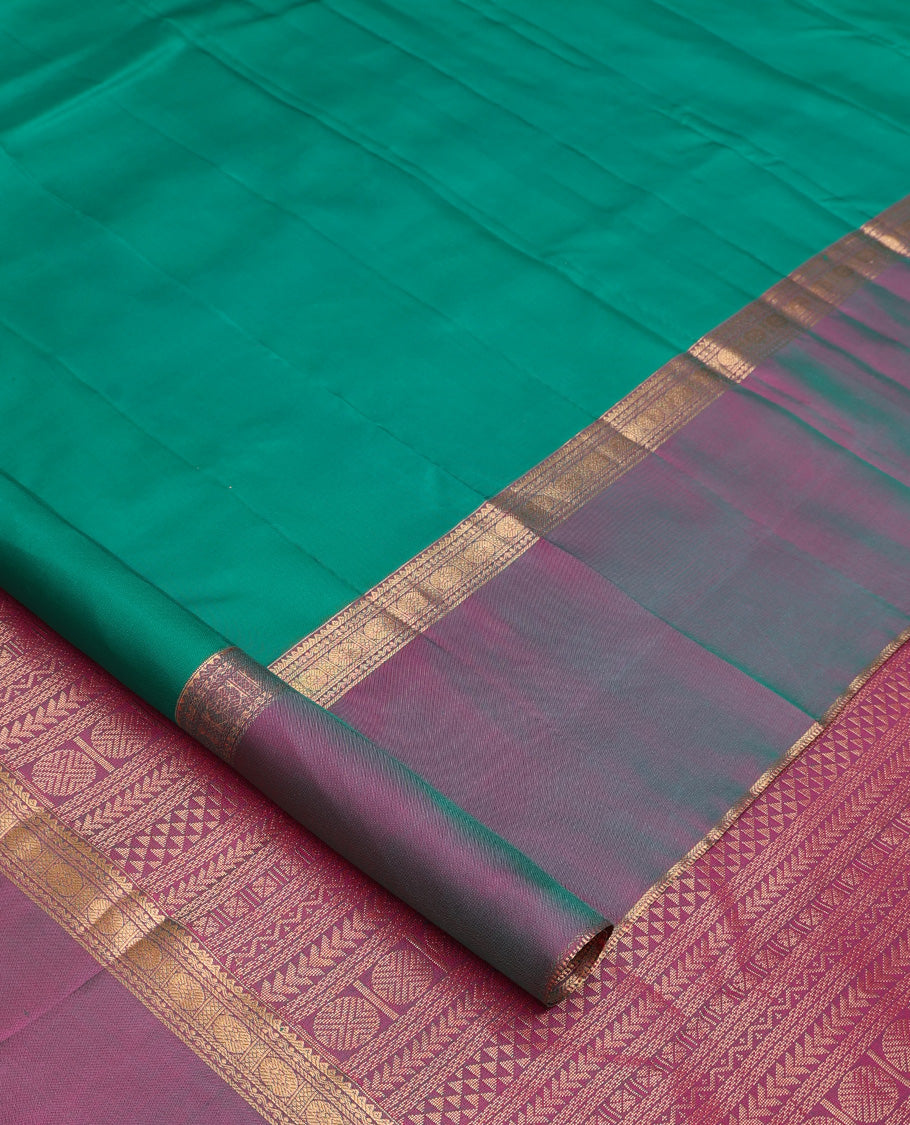 Green plain Kanchipuram silk saree, contrast ganga jamuna rettai pettu border of rekku, neli, banaras, and rudraksham designs, and pallu of kathir, rudraksham, neli, poun, ara bogudi, and ara maadam