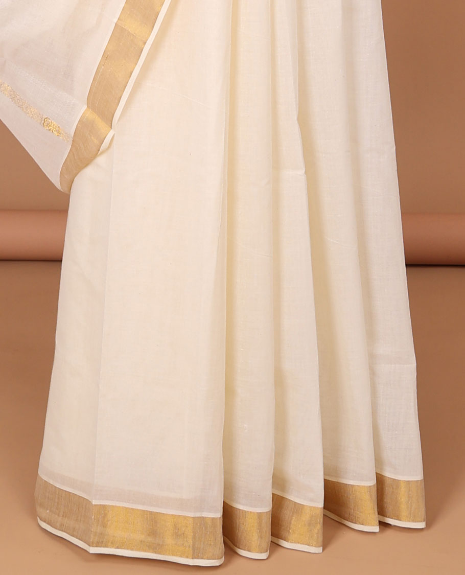 Cream kerala saree with zari stripes, zari border & pallu of peacock designs in zari