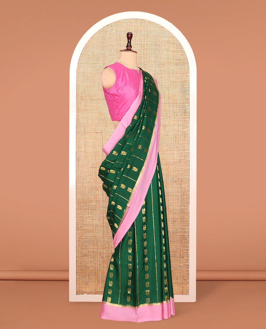 Green Mysore Silk Saree, Adorned With Zari Stripes and Peacock Buttas Across Its Body, Complemented by Captivating Contrast Border of Traditional Zari Designs, Pallu Steeped with Traditional Zari Designs, and Paired with a Contrast Blouse