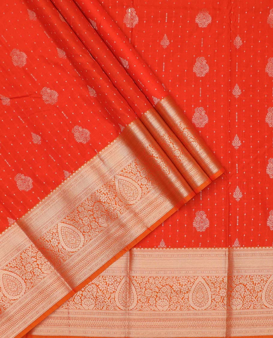 Orange art silk pavadai material, zari buttas with embossed contrast traditional zari border skirt, and matching blouse