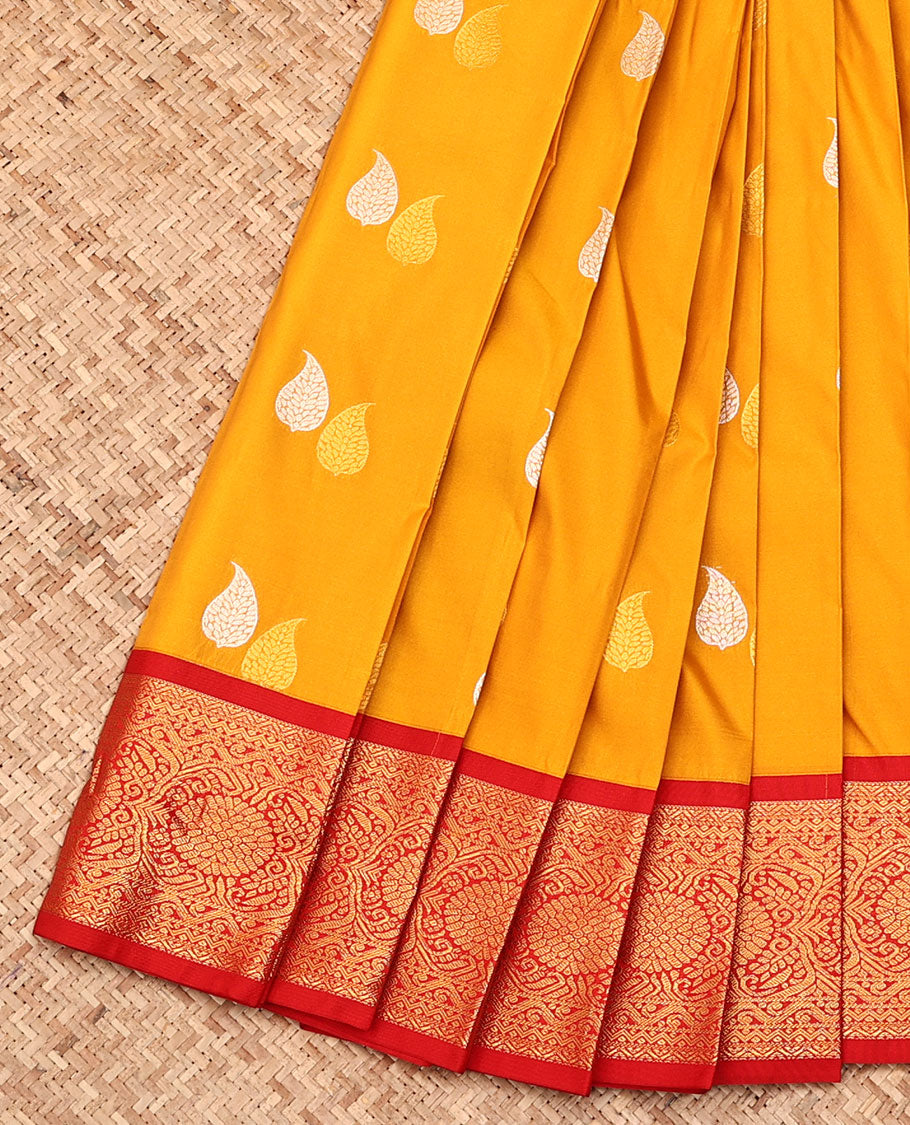 Yellow Budget Silk Saree, Ornamented with Leaf Buttas All Over Its Body, Complemented by a Contrast Traditional Zari Border, Grand Ogee Patterned Pallu, and Paired with a Contrast Blouse