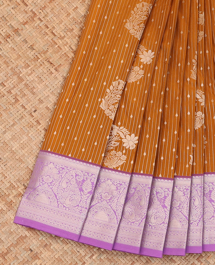 Orange Budget Silk Saree Artfully Detailed with Zari Stripes and Floral Buttas All Over Its Body, Complemented by a Contrast Traditional Zari Design Border, Pallu Opulently Embellished with Intricate Design, and Paired with a Contrast Blouse