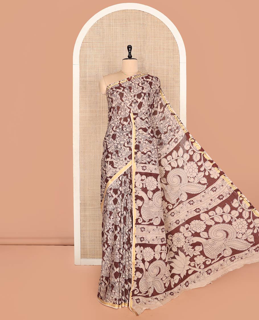 Brown Machine-Printed Kalamkari Cotton Saree Features Human Motifs, a Piping Border, Pallu of Peacocks, and a Matching Blouse