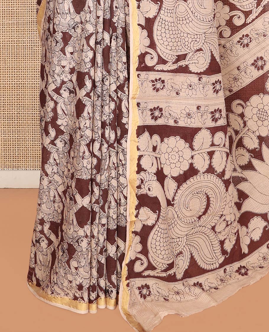 Brown Machine-Printed Kalamkari Cotton Saree Features Human Motifs, a Piping Border, Pallu of Peacocks, and a Matching Blouse