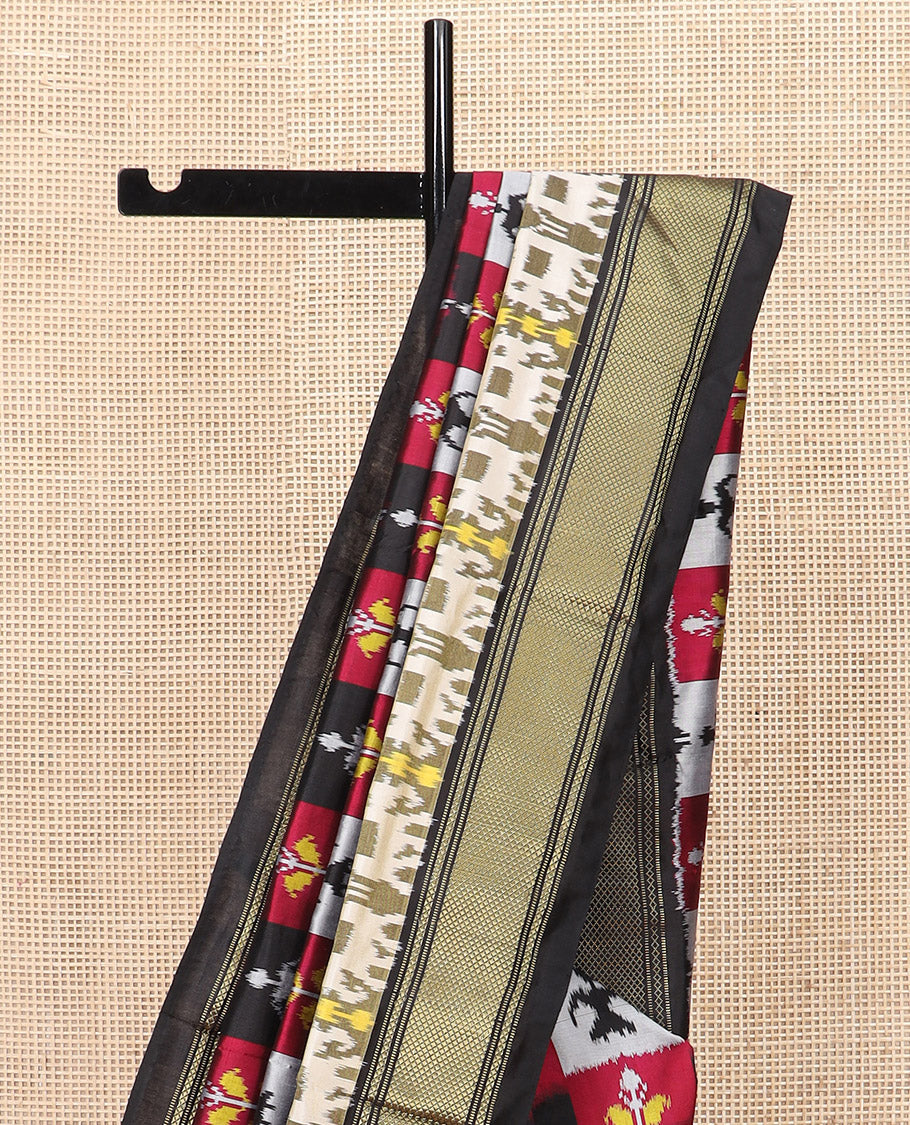 Multi-Colour Ikkat Silk Saree Features Warli Human Buttas and Flower Buttas, a Contrast Border Steeped with Traditional Zari Designs, a Pallu of Diamond Patterns, and a Contrast Blouse