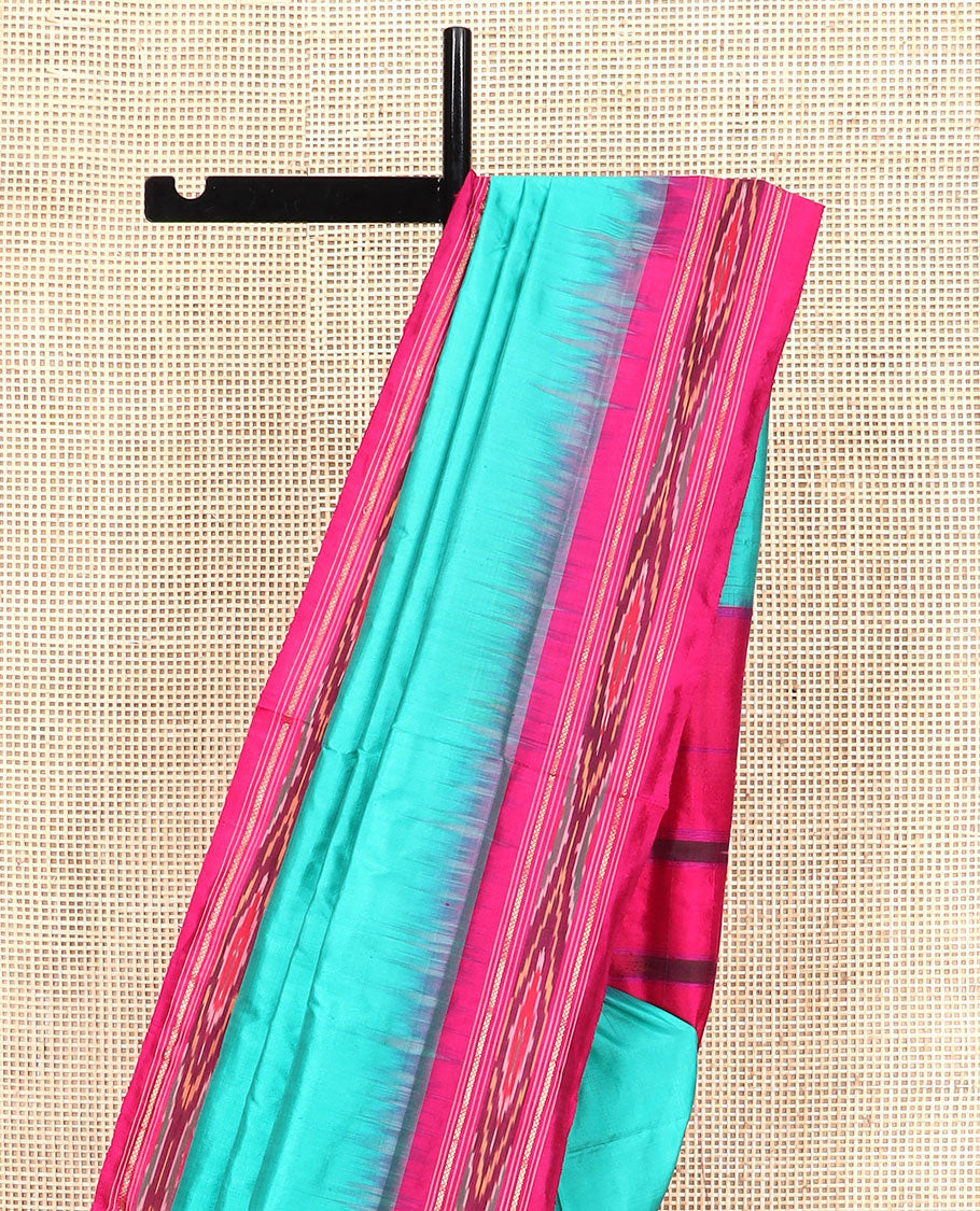 Turquoise Plain Ikkat Silk Saree with a Contrast Pink Border Completed by a Hazy Ikkat Weave, Featuring a Pallu with Stripes and Ikkat Texture