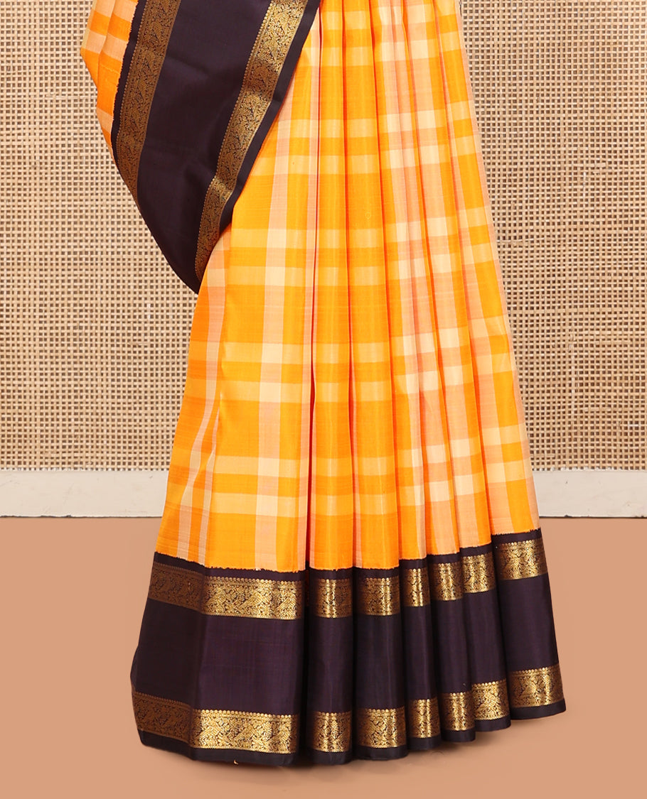 Orange Checked Kanchipuram Silk Saree, Complemented by a Contrast Korvai Rettai Pettu Border of Mayil Designs, Zari Striped Pallu, and a Contrast Blouse