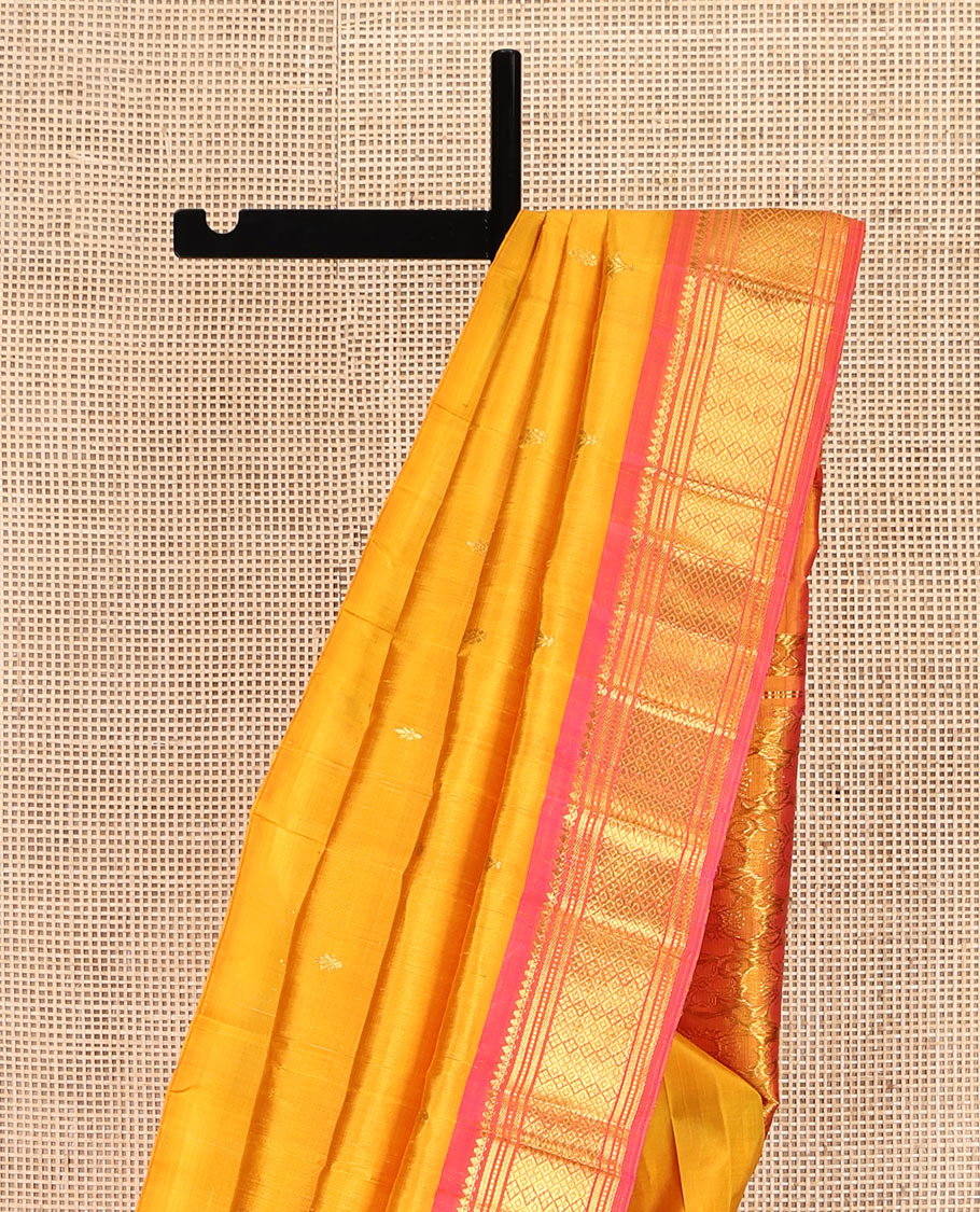 Orange Kanchipuram Silk Saree, Subtly Woven with Zari Buttas, Complemented by Contrast One-Sided Border of Thilakam Mokku, Banaras, Muthu, and Jaal Designs, Zari Design Pallu, and No Blouse