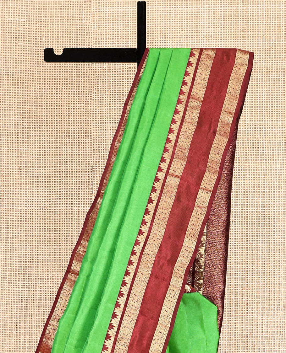 Green Plain Kanchipuram Silk Saree, Complemented by a Contrast Rettai Pettu Border of Thazampoo Rekku, Neli, Kuthirai, and Chakram Designs, Jaal Pallu, and a Contrast Blouse