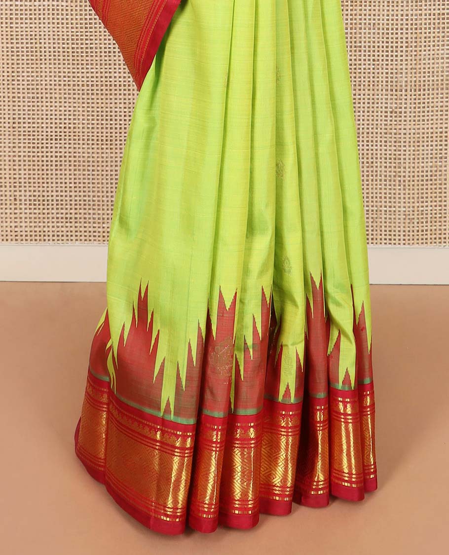 Green zari buttas Kanchipuram silk saree, contrast one-sided thazampoo rekku border of muthu, banaras, and jaal designs, and zari design pallu