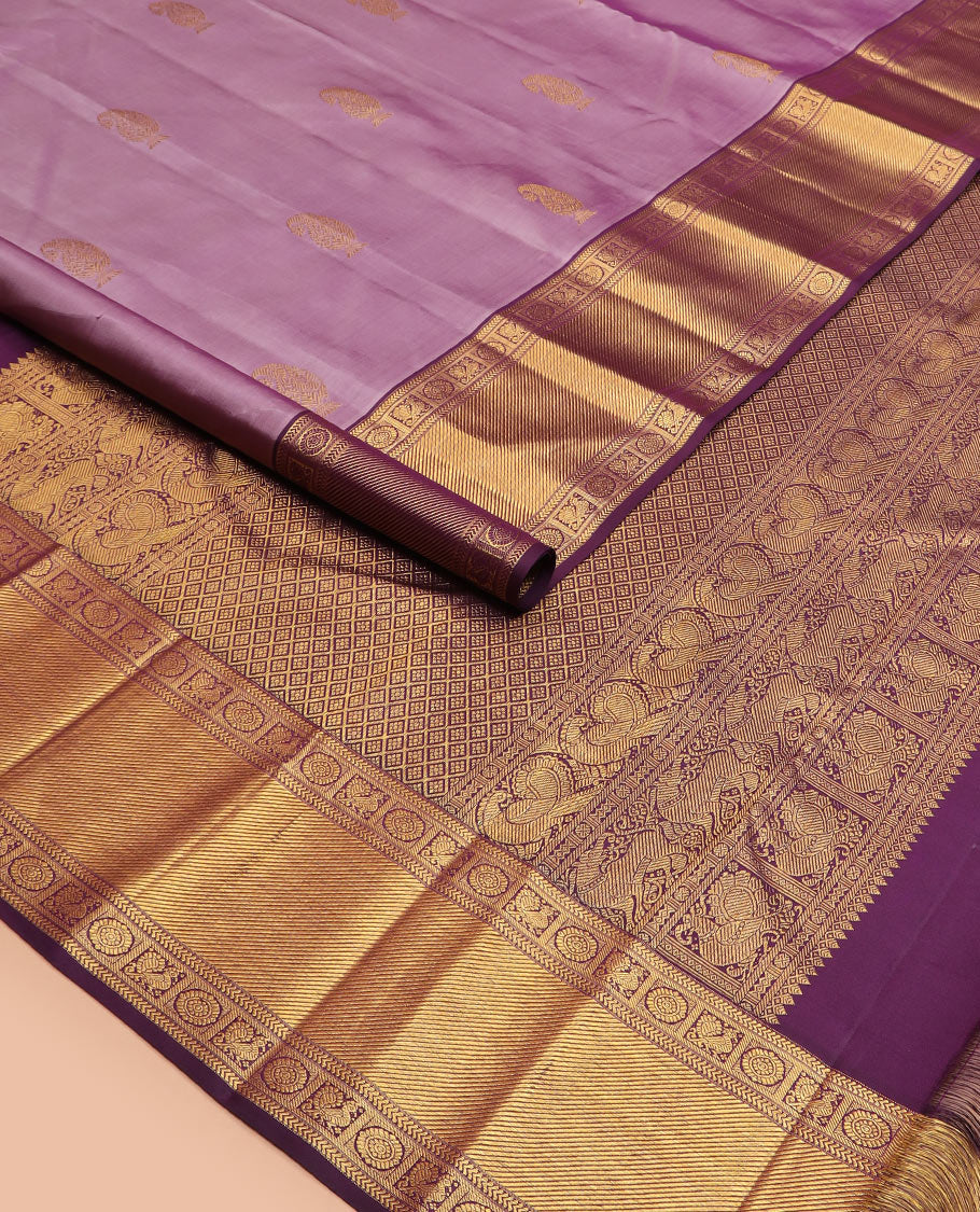 Purple manga buttas Kanchipuram silk saree, contrast border of kathir, and annam chakram designs, and zari-rich jaal pallu