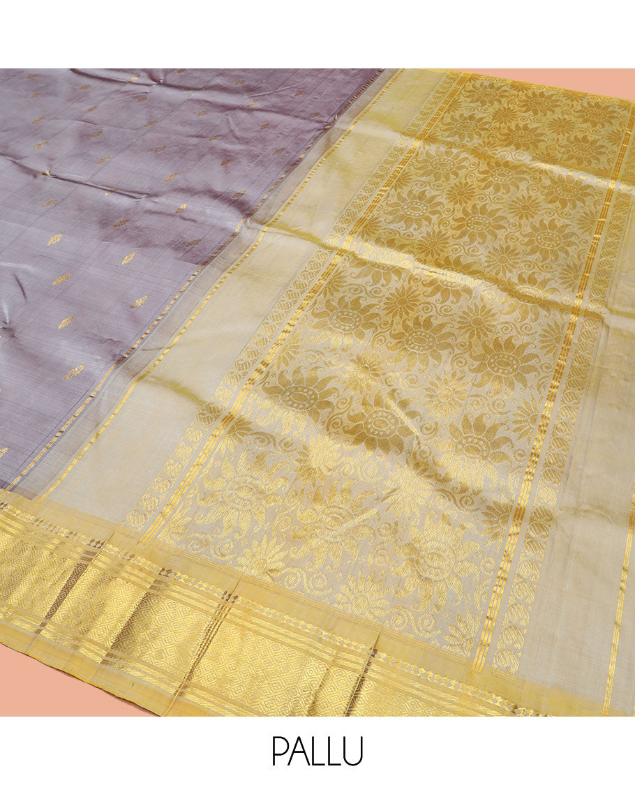Grey Kanchipuram Silk Saree Detailed with Zari Buttas, Highlighted by Contrast One-Sided Border of Paneer Sombu, Banaras, and Jaal Designs, Pallu Accentuated with Floral Zari Design, and Comes Without a Blouse