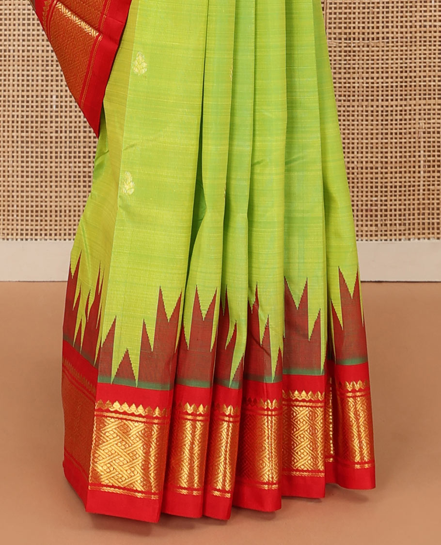 Parrot green zari buttas Kanchipuram silk saree, contrast one-sided thazampoo rekku traditional zari border, and zari design pallu