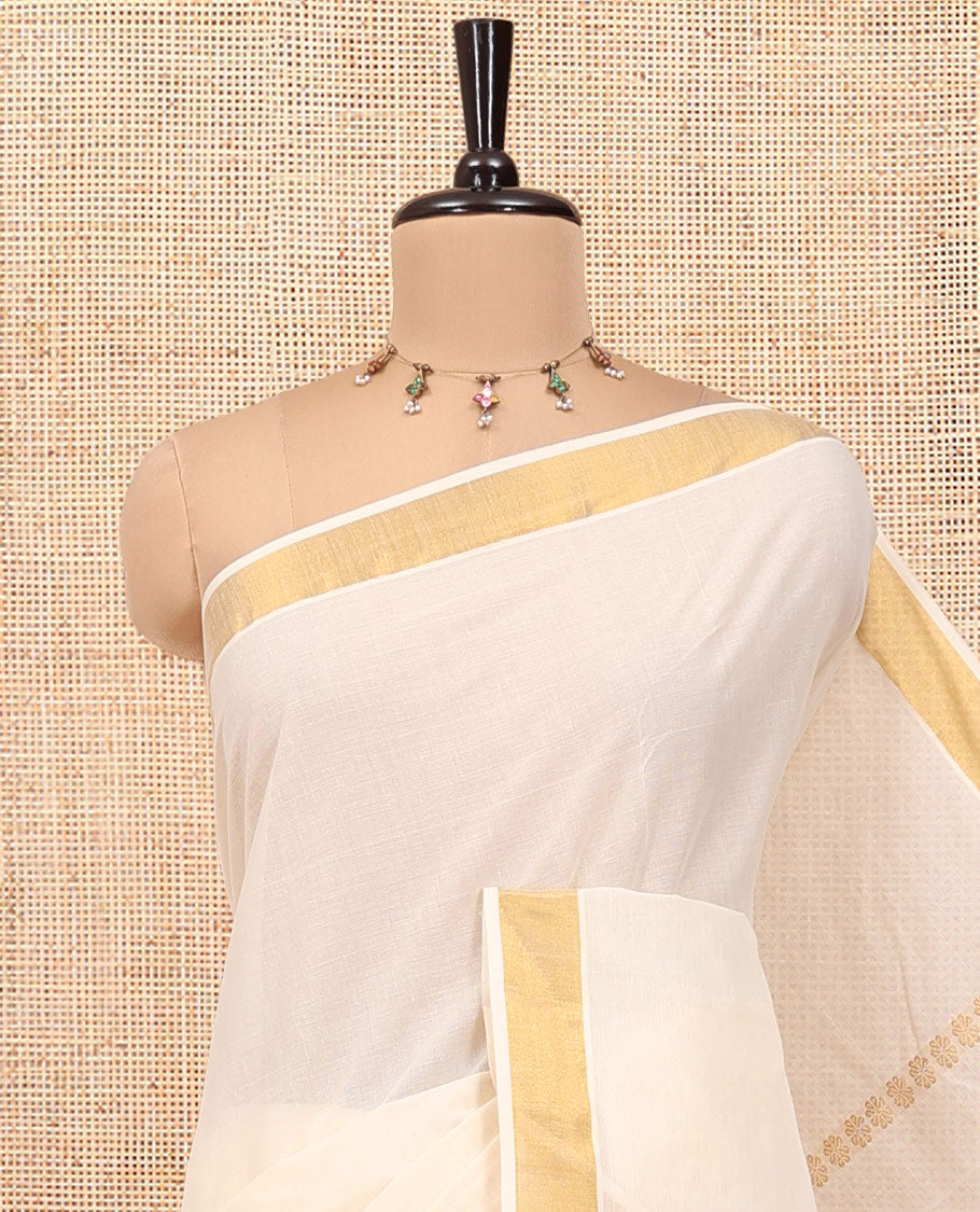 Cream Kerala Cotton Saree, Detailed with Zari Stripes All Over Its Body, a Subtle Bavanji Border, Pallu Features Peacock Designs, and Paired with a Matching Blouse