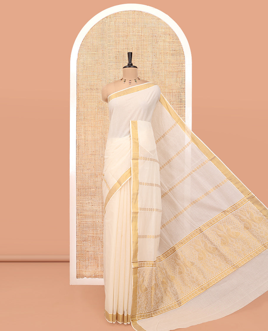 Cream Kerala Cotton Saree, Detailed with Zari Stripes All Over Its Body, a Subtle Bavanji Border, Pallu Features Peacock Designs, and Paired with a Matching Blouse