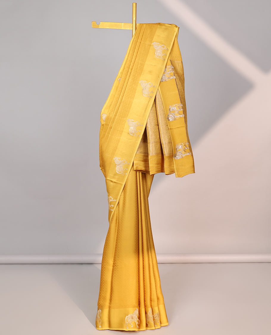 Yellow mushru silk saree with contrast horse motifs border & intricate zari design pallu