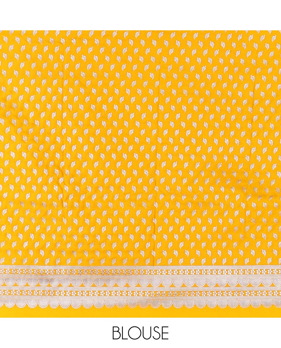 Yellow plain mushru silk saree, self-border of scallop design, floral, and tree motifs, and intricately designed pallu