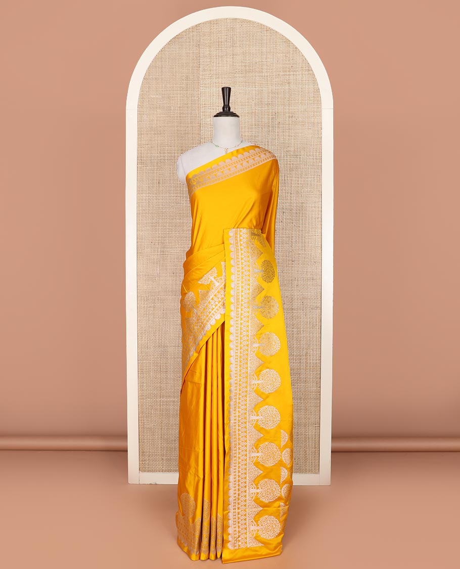 Yellow plain mushru silk saree, self-border of scallop design, floral, and tree motifs, and intricately designed pallu