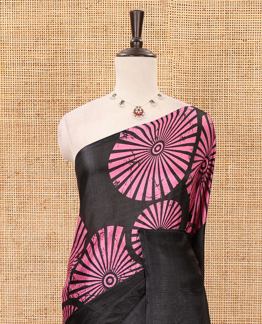 Black-base plain body khadi cotton saree with batik-style pink-color radiant sunburst design on its border & pallu, plain black blouse