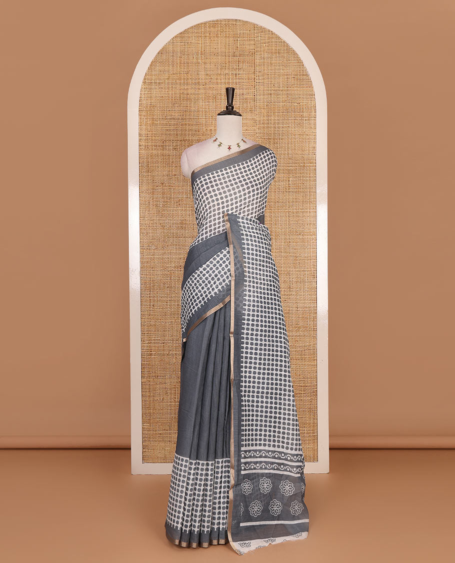 Grey plain and polka dots printed linen cotton saree with piping zari border, floral-geometric print pallu, and contrast flower buttas printed blouse