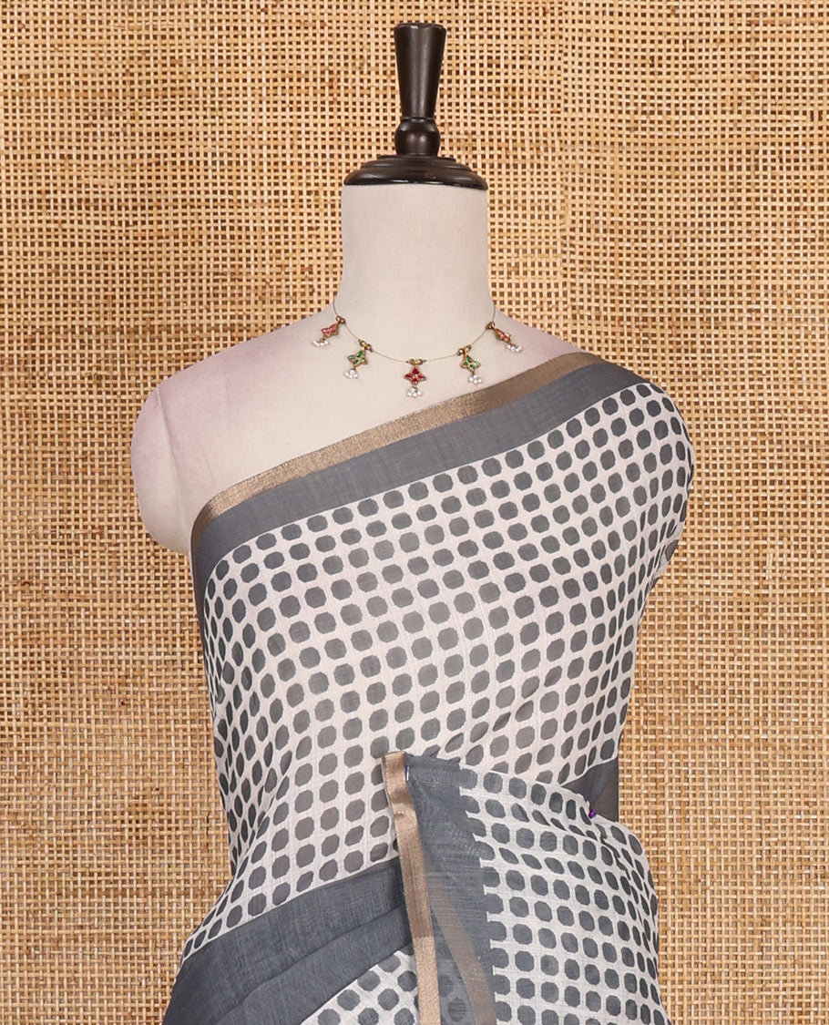 Grey plain and polka dots printed linen cotton saree with piping zari border, floral-geometric print pallu, and contrast flower buttas printed blouse