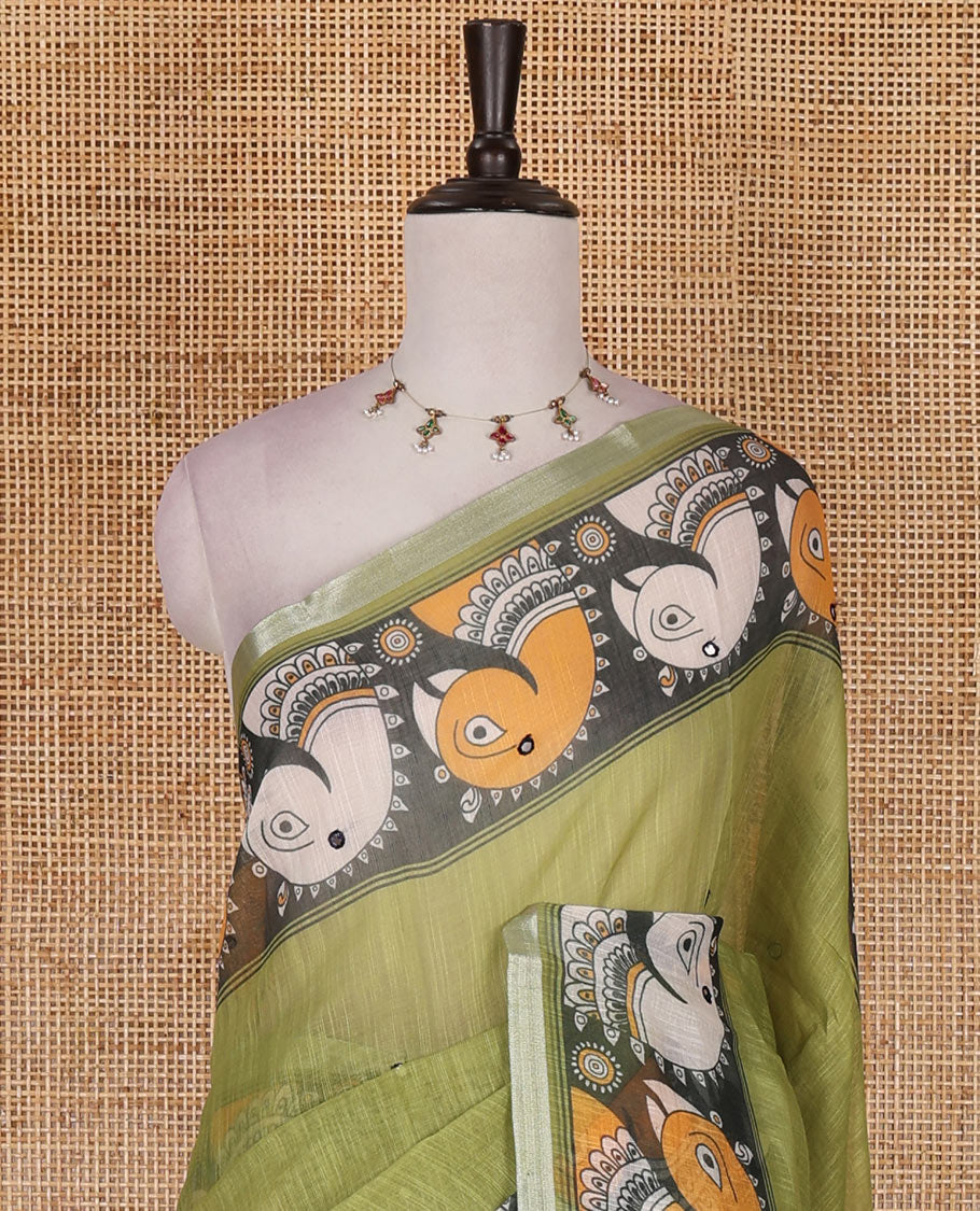 Green mirror thread embroidered linen saree, contrast kalamkari peacock printed border, pallu of kalamkari peacock and human figurines print, and printed blouse