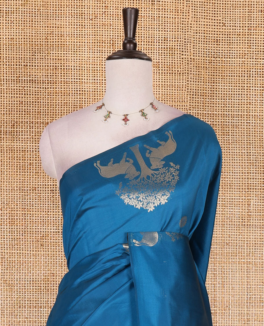 Borderless rama blue peacock, chakra, and pichwai cow buttas zari woven kanchi silk saree, peacock and chakra enclosed checked pallu, and matching blouse