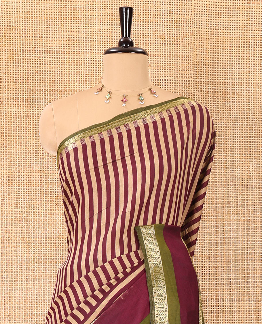 Wine vertically striped muslin silk saree, contrast zari rettai pettu border, kalamkari floral vine printed pallu, and a contrast plain blouse