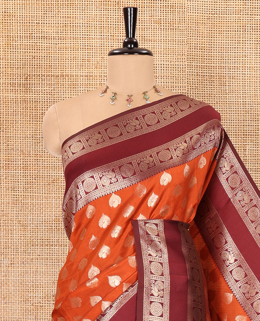 Rust orange zari buttas kanchi silk saree, contrast traditional rettai pettu border of peacock chakram, intricate pallu, and a zari design pallu