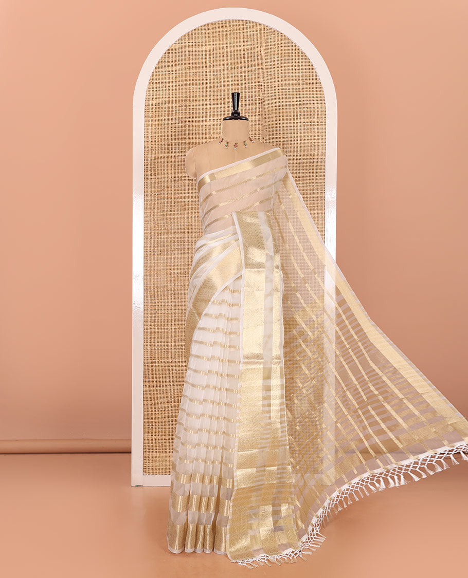 Half-white zari design semi-organza saree, traditional zari design border of floral creeper designs, zari striped pallu, and a matching blouse